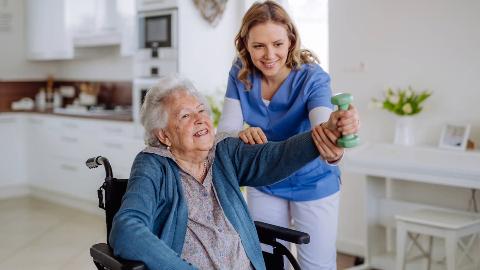 Nurse helping a man move around his home.